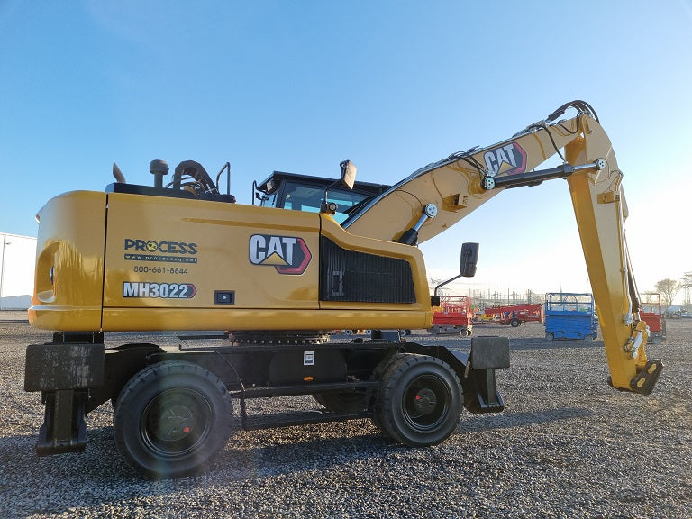 Caterpillar MH 3022 Material Handler on solid tires with 2-piece boom and stick with bucket linkage