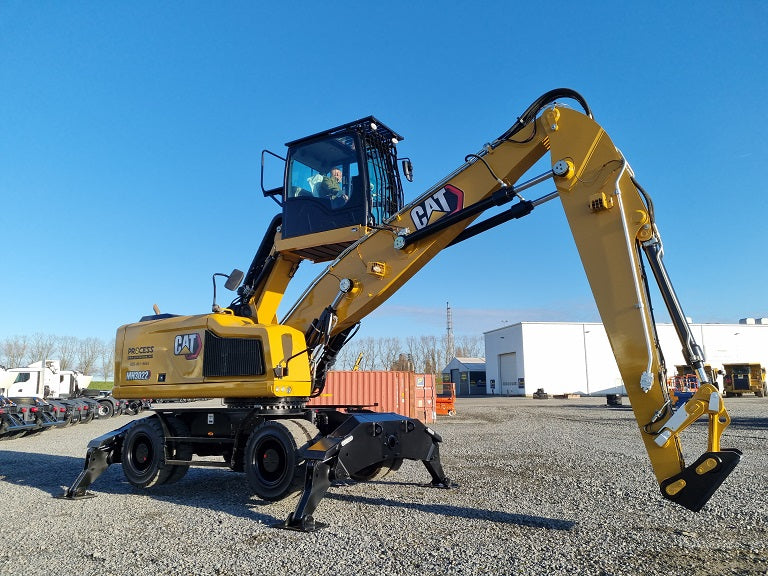 Caterpillar Material Handler with bucket linkage for a trash grapple