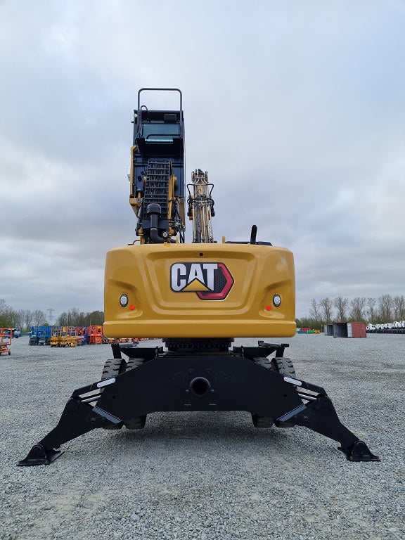Backside of a Caterpillar MH 3024 Material Handling machine with outriggers and extended cab