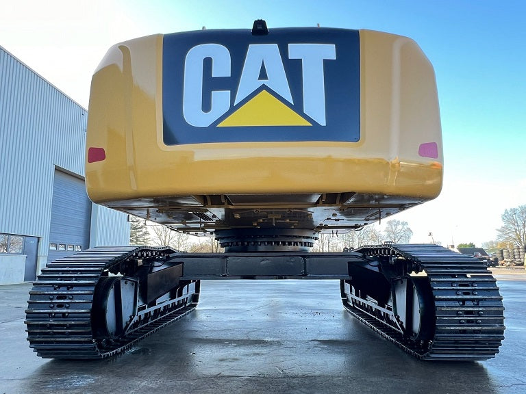 Rear view of a Caterpillar material handler on tracks with a rear-view camera