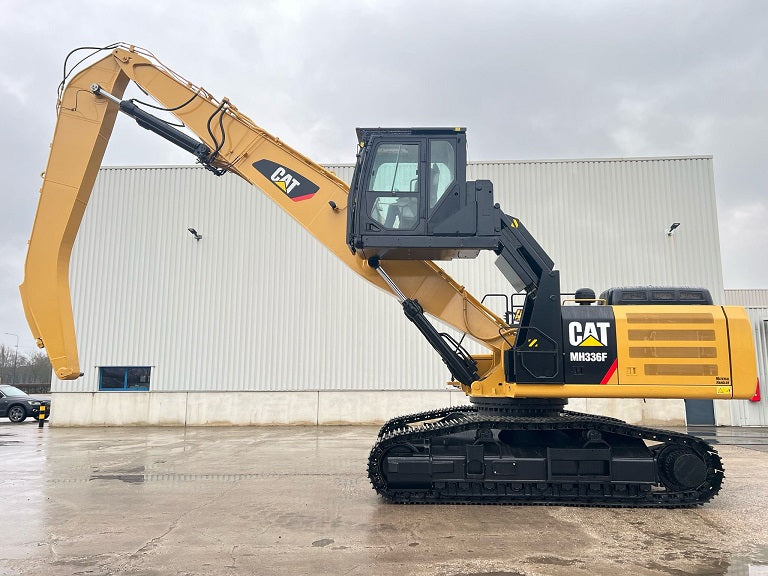 Refurbished Caterpillar Material Handler Model MH 336F with a hydraulic elevating cab, heavy duty undercarriage and 24" track shoes