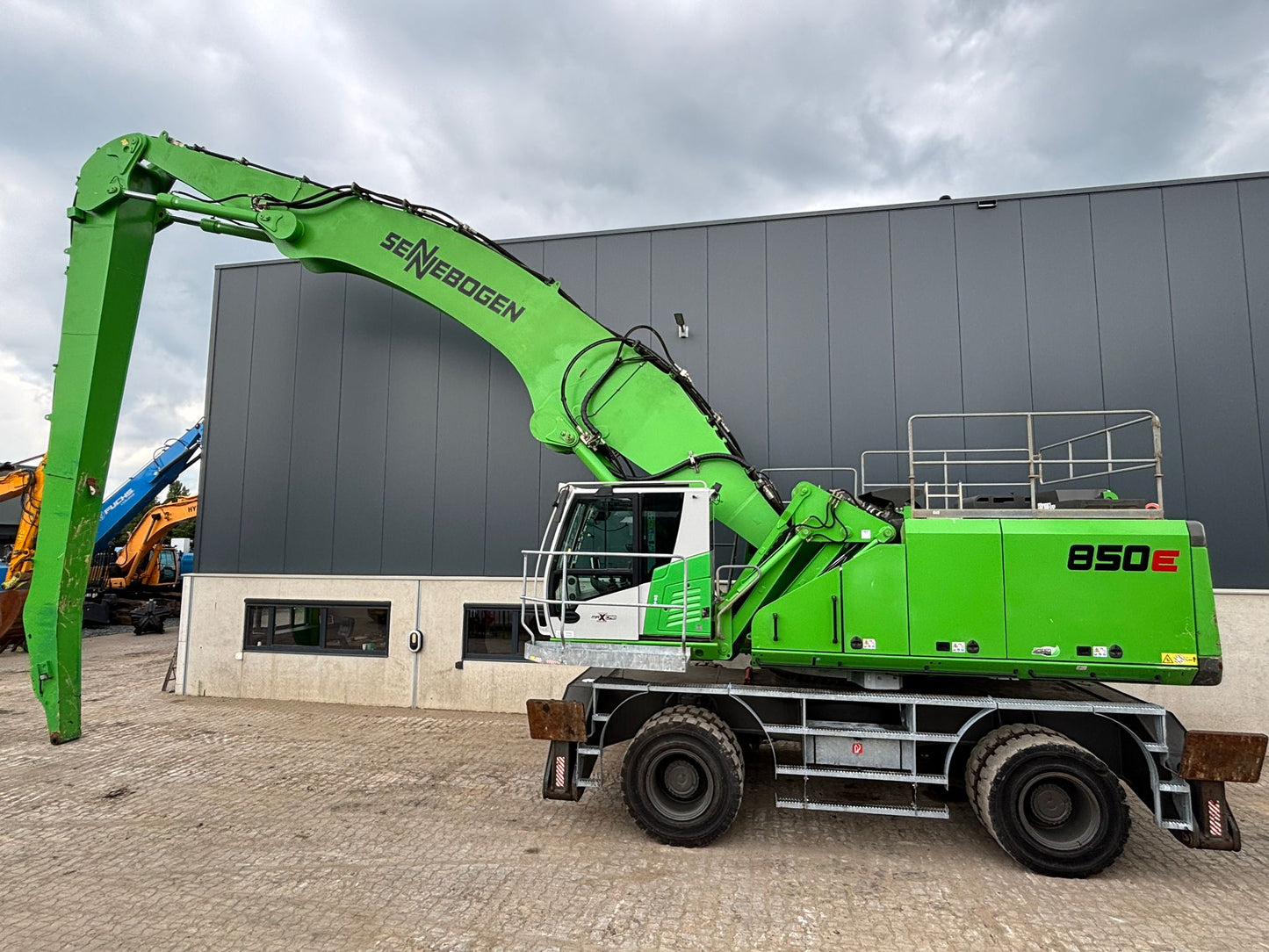 Sennebogen 850M E Material Handling machine with operators landing, upper railing package on solid tires