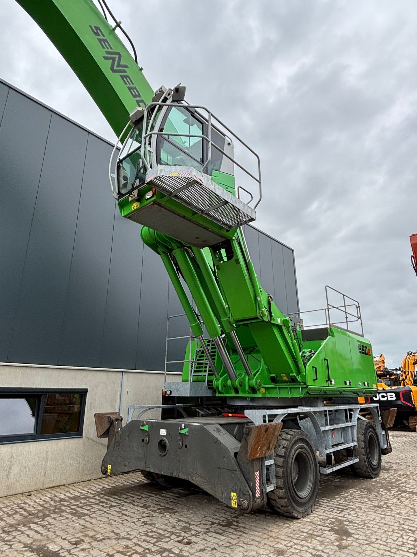 Sennebogen 850M E material handling machine with hydraulically elevated cab and operators landing