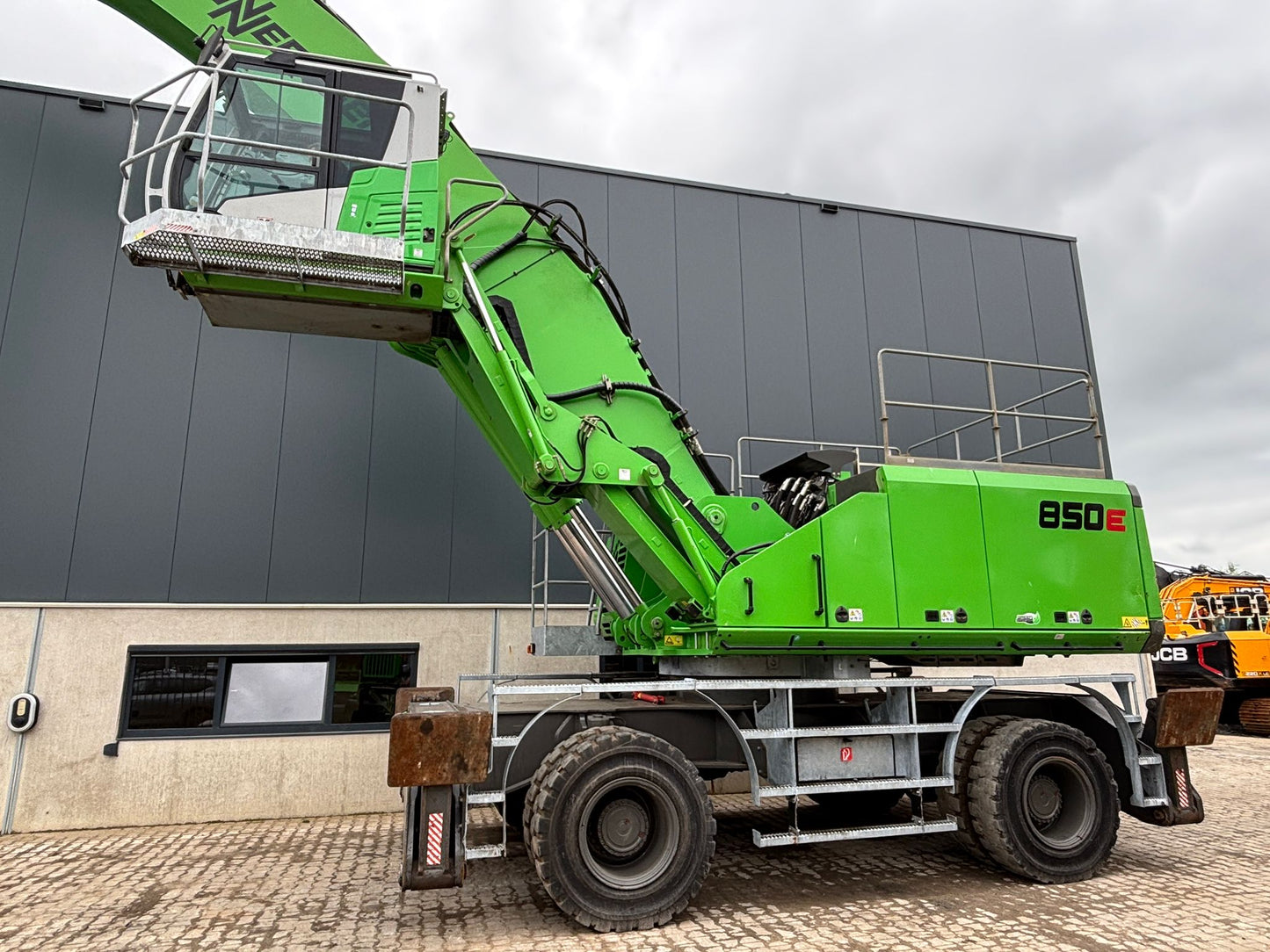 Used material handling machine on solid rubber tires with a hydraulic elevated cab