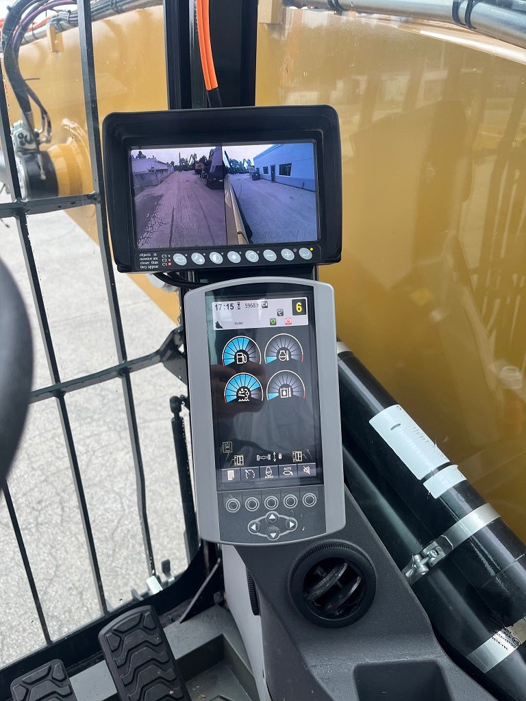 Close-up of a Caterpillar MH 3022 Material Handler display screen with camera feed and control panel.