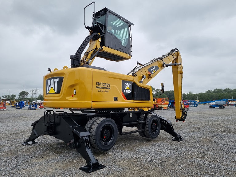 MH 3024 material handling machine with hydraulically elevated cab, solid tires with outriggers 