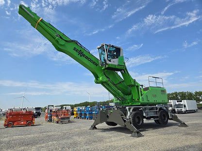 Sennebogen material handling machine with hydraulic elevating cab, on solid tires